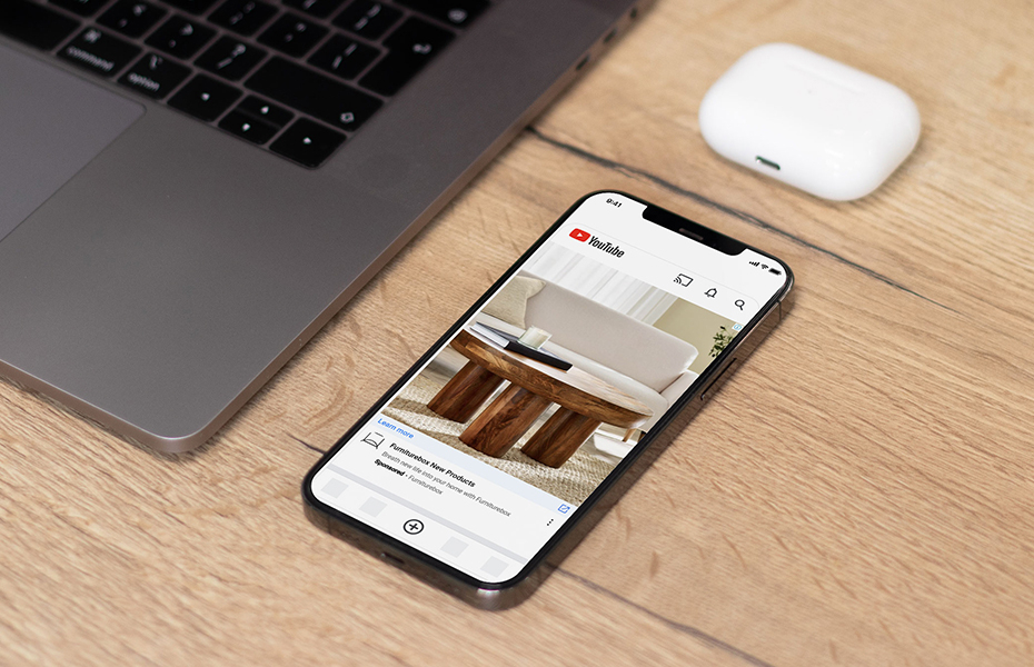 Mobile mockup of a Furniturebox Youtube Ad on a desk